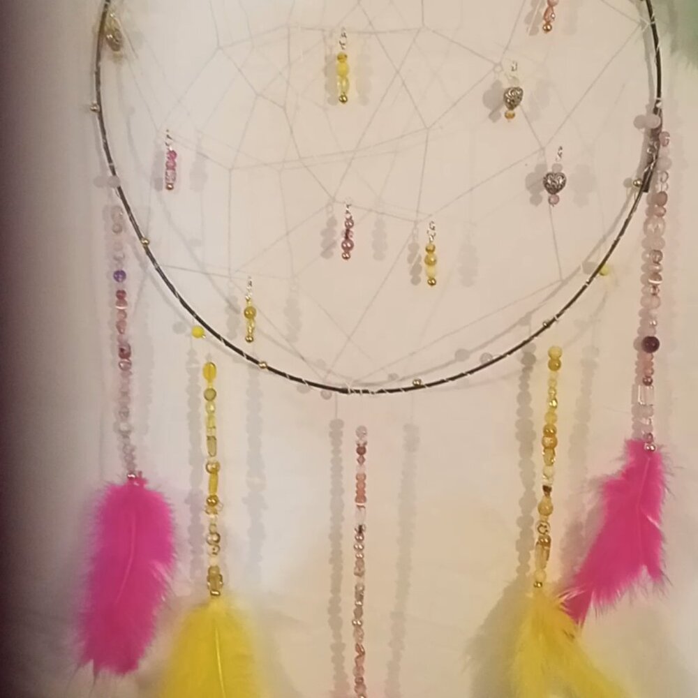Handmade pink and yellow dream catcher with hearts